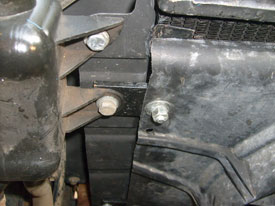 Top metal tab. Drivers side. Power steering reservoir to the left.